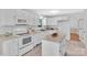 The kitchen boasts white cabinets, sleek appliances, a modern island, and a functional design for cooking and entertaining at 2216 Lowell Bethesda Rd, Gastonia, NC 28056