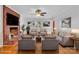 Comfortable living room showcasing a brick fireplace, plush seating, and a view through a window at 2216 Lowell Bethesda Rd, Gastonia, NC 28056