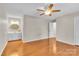 Spacious bedroom with wood floors, ceiling fan, and ensuite bathroom, providing ample space and convenience at 2216 Lowell Bethesda Rd, Gastonia, NC 28056