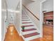 Inviting foyer featuring hardwood floors and an open stairway with wood detailing at 2216 Lowell Bethesda Rd, Gastonia, NC 28056