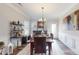 Elegant dining room featuring a wooden table set for four and a stylish wine rack for entertaining guests at 280 Kerri Dawn Ln, Locust, NC 28097