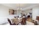 Dining room featuring a wood table, seating for six, and view into kitchen at 280 Kerri Dawn Ln, Locust, NC 28097
