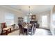Bright dining room with wood table, seating for six, wainscoting, and ample natural light at 280 Kerri Dawn Ln, Locust, NC 28097