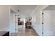 Hallway view showcasing wood floors and multiple rooms including the kitchen and living room at 280 Kerri Dawn Ln, Locust, NC 28097
