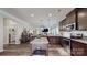 Open kitchen featuring a granite island, stainless steel appliances, and dark wood cabinets overlooking the living room at 280 Kerri Dawn Ln, Locust, NC 28097