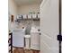Laundry room with white washer and dryer, storage shelves, and a white door at 280 Kerri Dawn Ln, Locust, NC 28097