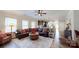 Spacious living room featuring hardwood floors, a leather sofa, and a ceiling fan at 280 Kerri Dawn Ln, Locust, NC 28097