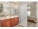 Bathroom view with double sink vanity, with view to Primary bedroom, white door, and neutral colors at 284 Garnet Ct, Fort Mill, SC 29708