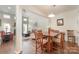Open-concept dining room with hardwood floors, adjacent to the living area at 284 Garnet Ct, Fort Mill, SC 29708