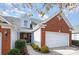 Charming brick and vinyl home featuring an attached garage and well-manicured landscaping at 284 Garnet Ct, Fort Mill, SC 29708