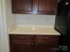 Wooden kitchen cabinets with white countertops and appliances at 284 Garnet Ct, Fort Mill, SC 29708