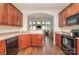 Well-lit kitchen with stainless steel appliances, dark wood cabinets, and an arched doorway to the living room at 284 Garnet Ct, Fort Mill, SC 29708