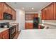 Bright kitchen featuring dark wood cabinets, modern appliances, and laminate countertops at 284 Garnet Ct, Fort Mill, SC 29708