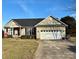 Tan colored house with a two-car garage at 328 Holstein Dr, Dallas, NC 28034