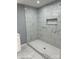 Bathroom shower with gray and white marble tile and mosaic floor at 3596 Bethany Church Rd, Claremont, NC 28610