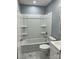 Bathroom featuring a tub/shower combo with white tile surround and marble tile floors at 3596 Bethany Church Rd, Claremont, NC 28610