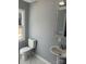 This bathroom features a toilet, sink with a stylish mirror, and a window for natural light at 3596 Bethany Church Rd, Claremont, NC 28610