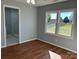 Bedroom featuring wood flooring and windows with view into the backyard at 3596 Bethany Church Rd, Claremont, NC 28610