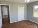 Bedroom featuring wood flooring, closet, and window with view of outside at 3596 Bethany Church Rd, Claremont, NC 28610