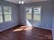 Bedroom featuring wood flooring, light-filled windows, and neutral wall colors at 3596 Bethany Church Rd, Claremont, NC 28610