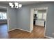 Bright dining room features hardwood floors and chandelier at 3596 Bethany Church Rd, Claremont, NC 28610