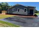 Home with new siding, white windows, an extended driveway, landscaping and a wooden porch at 3596 Bethany Church Rd, Claremont, NC 28610