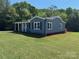 Well-maintained home boasts new siding, classic windows, a covered porch, and green lawn at 3596 Bethany Church Rd, Claremont, NC 28610