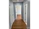 Hallway with wood flooring, neutral walls, and multiple doorways at 3596 Bethany Church Rd, Claremont, NC 28610