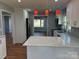 Open kitchen with island, granite counters, stainless appliances, and hardwood floors at 3596 Bethany Church Rd, Claremont, NC 28610
