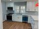 Bright kitchen features stainless appliances, white cabinets, and hardwood floors at 3596 Bethany Church Rd, Claremont, NC 28610