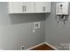 Laundry room with hardwood floors and utility sink at 3596 Bethany Church Rd, Claremont, NC 28610