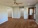 Spacious living room with ceiling fan, wood floors, and multiple entryways to other rooms at 3596 Bethany Church Rd, Claremont, NC 28610