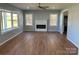 Spacious living room features a fireplace, wood flooring, and large windows for natural light at 3596 Bethany Church Rd, Claremont, NC 28610
