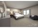 Main bedroom with plush bed, nightstands and a seating area at 4011 Bufflehead Dr, Charlotte, NC 28269