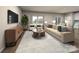 Living room with beige sofa, wood coffee table, and access to kitchen at 4011 Bufflehead Dr, Charlotte, NC 28269