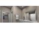 Bathroom with double sink vanity, large mirror, towel rack, white paint, and view of the door to another room at 4019 Bufflehead Dr, Charlotte, NC 28269