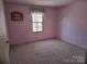 View of the bedroom with light pink paint and carpeted flooring at 5320 Liberty Hill W Rd, York, SC 29745