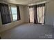 Neutral carpeted bedroom with a window and sliding glass door at 5320 Liberty Hill W Rd, York, SC 29745