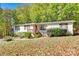 Charming home with a yard covered in leaves and surrounded by lush green trees at 5320 Liberty Hill W Rd, York, SC 29745