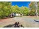 Front view of single story home with yard, mature trees, and a gravel driveway at 5320 Liberty Hill W Rd, York, SC 29745