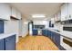 Traditional kitchen with blue and white cabinetry and laminate flooring throughout at 5320 Liberty Hill W Rd, York, SC 29745