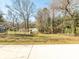 Large backyard with partial fence, mature trees, and partial view of the home at 1209 Moretz Ave, Charlotte, NC 28206