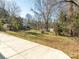 Large backyard with a partial fence, mature trees, and partial view of the home at 1209 Moretz Ave, Charlotte, NC 28206