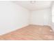 Well-lit bedroom with light colored wood floors and two doors at 1209 Moretz Ave, Charlotte, NC 28206