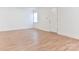 Bedroom featuring light-colored wood floors, with one window and a door at 1209 Moretz Ave, Charlotte, NC 28206