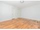 Empty bedroom with hardwood floors, featuring white walls and two doors at 1209 Moretz Ave, Charlotte, NC 28206