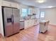 Bright kitchen with white cabinets, stainless steel appliances, and a butcher block island at 1209 Moretz Ave, Charlotte, NC 28206