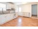 Traditional-style kitchen featuring white cabinetry, light countertops and wood flooring at 1209 Moretz Ave, Charlotte, NC 28206