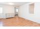 Cozy living area featuring wood-look floors, a brick accent wall, and lots of light at 1209 Moretz Ave, Charlotte, NC 28206