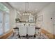 Bright dining area featuring a dining table with seating for six, light fixture, and kitchen in the background at 14027 Grand Traverse Dr, Charlotte, NC 28278